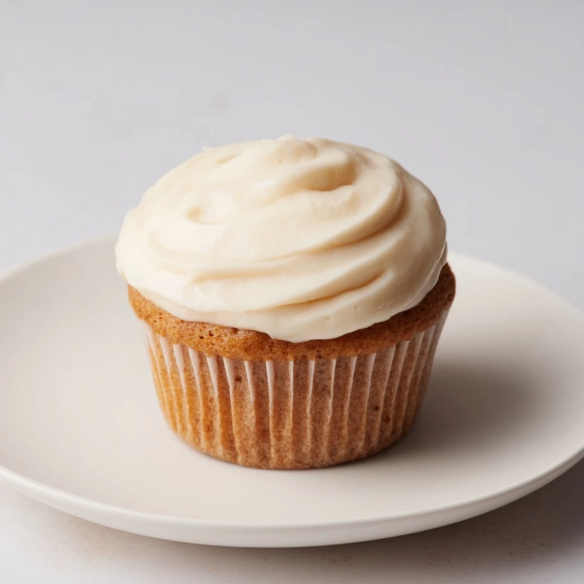 Frosted vanilla cupcakes, perfectly baked with a creamy buttercream, ready to enjoy at home.