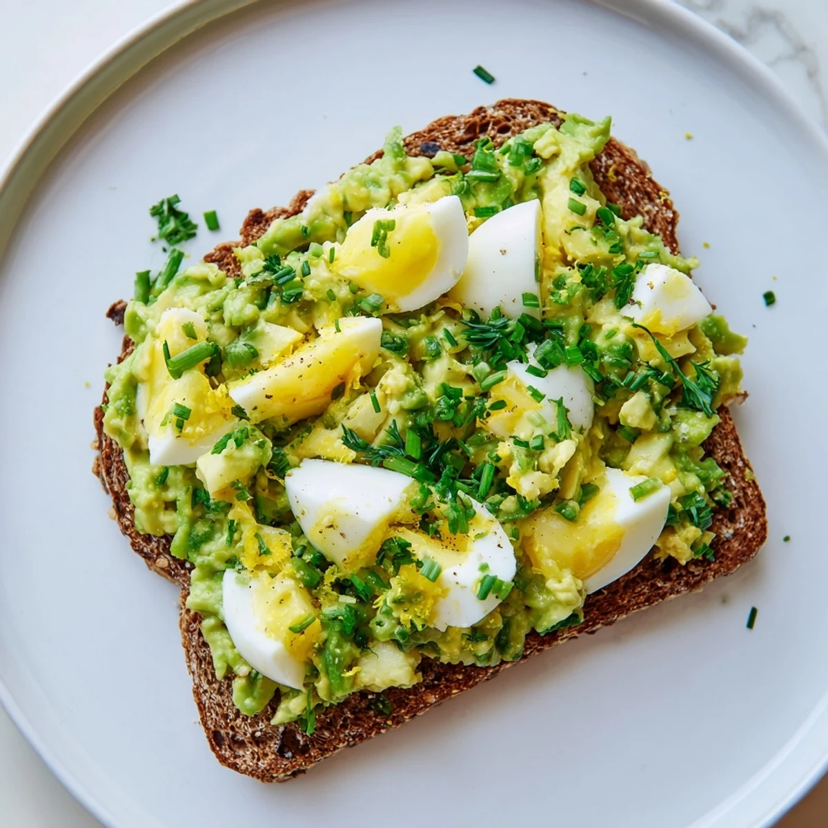Creamy Avocado Egg Smash on toasted bread, a breakfast or lunch delight.