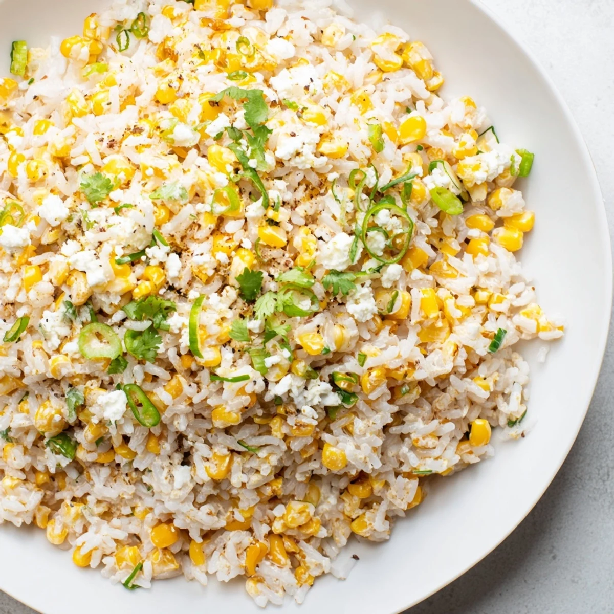 Fluffy Mexican Street Corn Rice, loaded with charred corn, cotija, and zesty lime, a vibrant side!