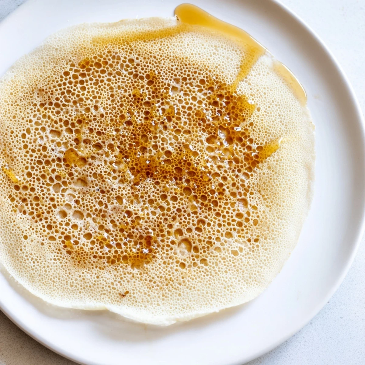 Close-up on the airy and holey texture of the authentic Moroccan Baghrir; perfect for breakfast.