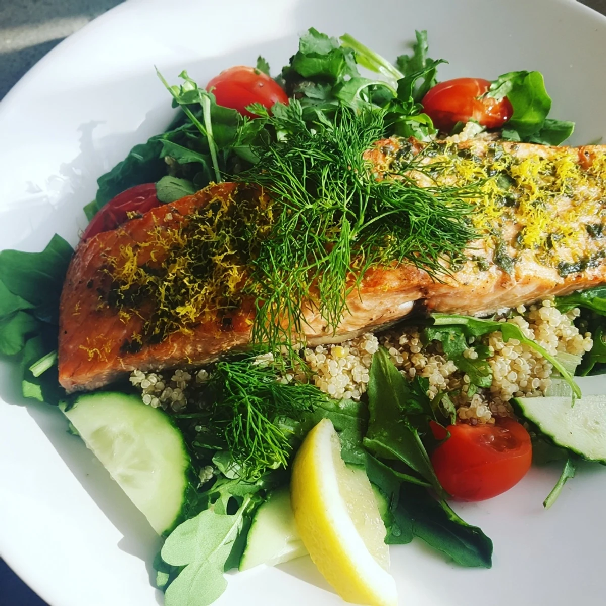Warm Lemon Herb Salmon Salad featuring flaky fish atop quinoa, greens, and a zesty vinaigrette.
