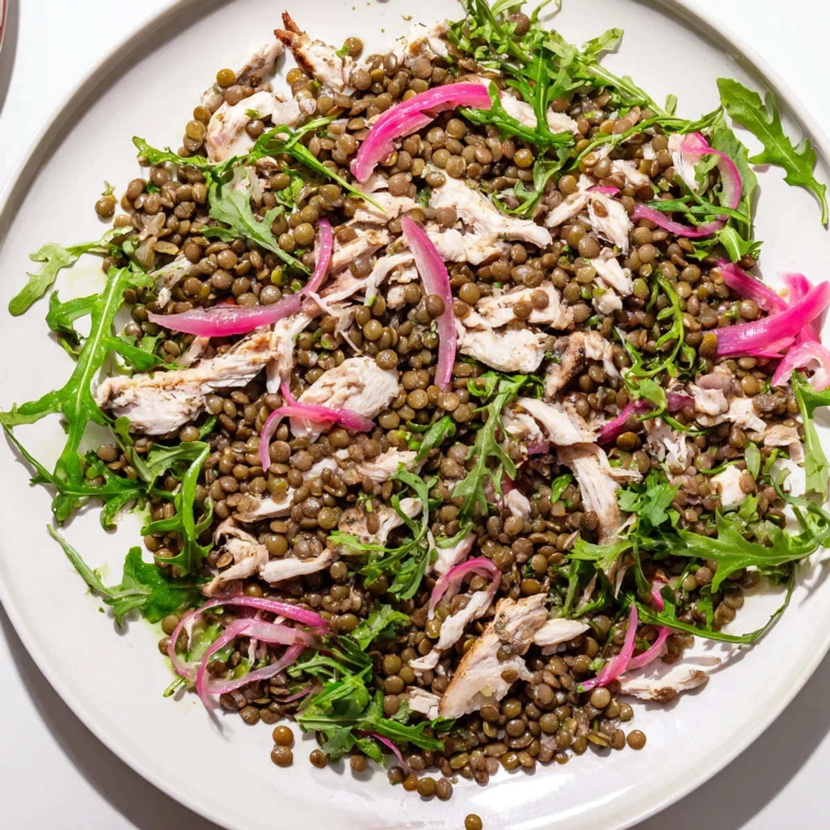 Serve Lentil & Chicken Spring Salad on a plate with succulent chicken, lentils, and crisp vegetables tossed in a tangy Dijon vinaigrette.