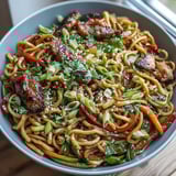 Colorful vegetables like carrots and snap peas add crunch to this quick and easy weeknight Pork Noodle Stir-Fry.  