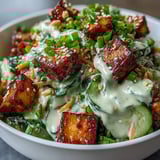 Cool sliced cucumbers and carrots tossed in a creamy sesame-ginger dressing and topped with ultra-crispy tofu.