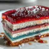 Showstopping rainbow jelly cake, a dairy-free delight with layers of fruity flavor.