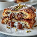Crispy, warm croissant French toast filled with melted chocolate, pistachios.