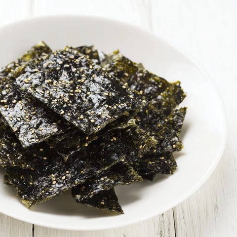 Crispy roasted seaweed chips with a light, savory crunch, brushed with sesame oil and salt.  
