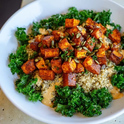 A colorful Light Coastal Bowl, with tender vegetables, quinoa, and a creamy lemon-tahini dressing to drizzle.