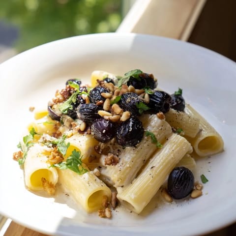 Creamy ricotta coats pasta mingling with sweet red grapes in this delicious recipe.