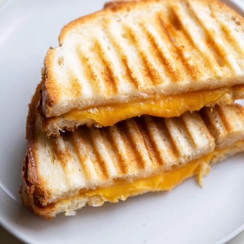 Imagining a warm, cheesy Waffle Grilled Cheese, perfectly pressed in a waffle iron, ready to enjoy.