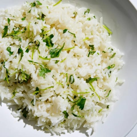 Steaming bowl of Cilantro Lime Rice, bursting with lime and cilantro flavors, perfect side dish.
