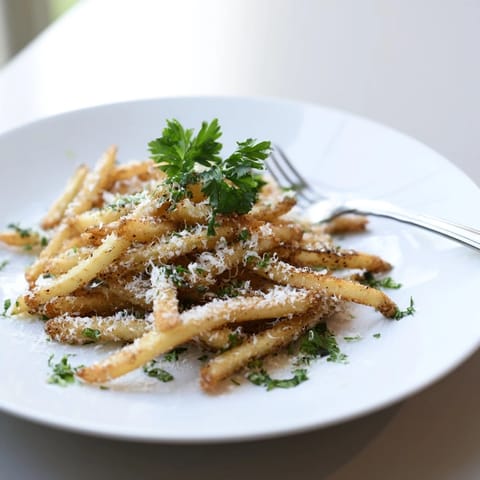 Crispy baked russet fries topped with freshly grated Parmesan and a drizzle of aromatic truffle oil.