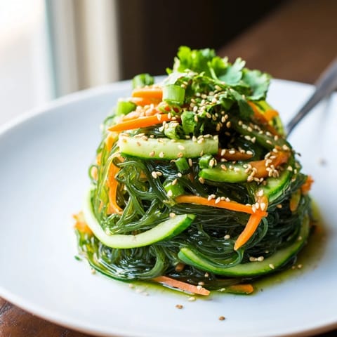 Close-up of Seaweed Salad showing tender seaweed strands and bright sesame seeds, served fresh for a light, refreshing appetizer.