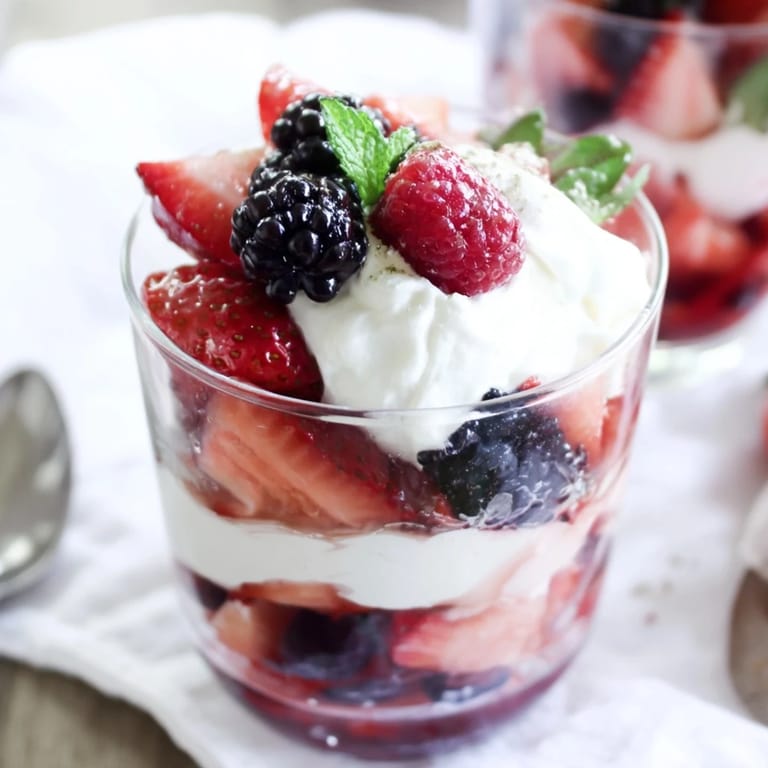 A beautifully layered Berry Parfait, a sweet and refreshing dessert, ready to delight your taste buds.