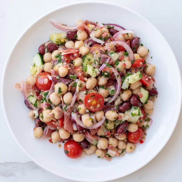 Vibrant Dense Bean Salad with Prosciutto featuring salty prosciutto and colorful chopped vegetables.
