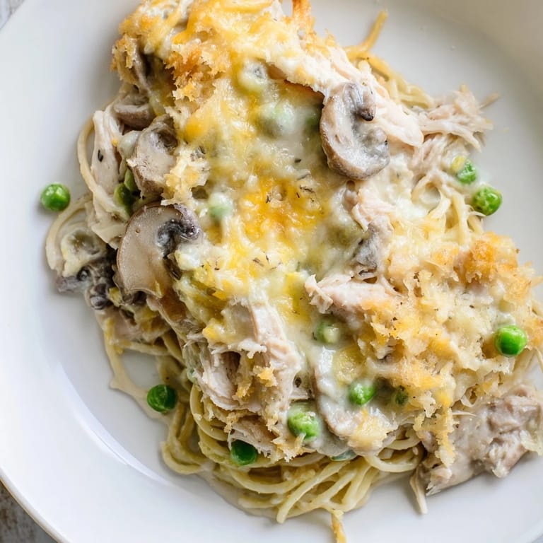 This delicious Turkey Tetrazzini, baked until bubbly, presents a classic comfort food dinner on the table.
