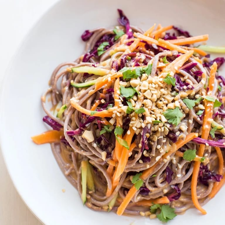 Cold soba noodle salad featuring tender buckwheat noodles and crunchy vegetables, ready to enjoy.