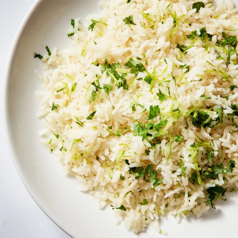 A vibrant close-up shows the finished, flavorful Cilantro Lime Rice, ready to serve and enjoy.