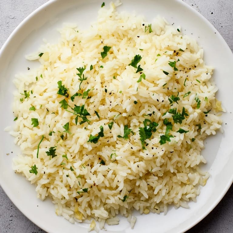 Steaming Garlic Butter Rice, a comforting and buttery side, perfect alongside grilled chicken.