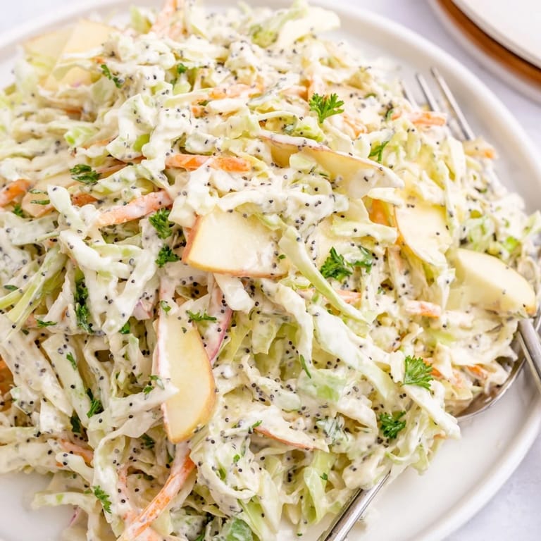 Colorful bowl of Green Cabbage and Apple Slaw with fresh ingredients, ready for a summer picnic or barbecue side dish.