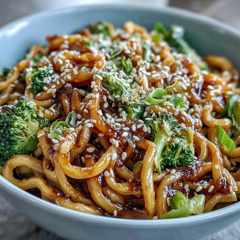 Ready-to-serve Asian Teriyaki Noodle Bowl garnished with green onions and sesame seeds, perfect for a quick weeknight dinner.